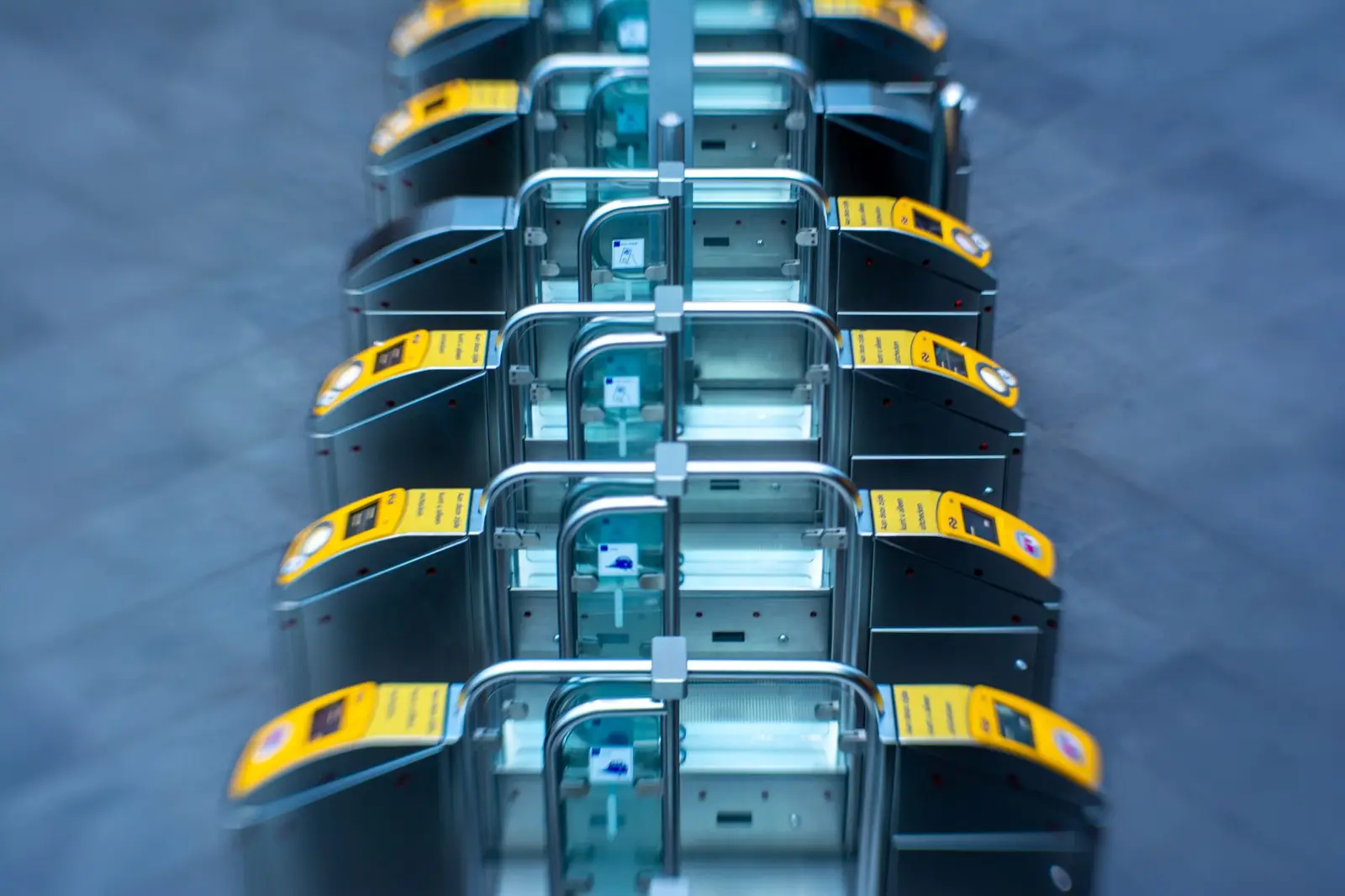 A row of access turnstiles with readers, seen up close